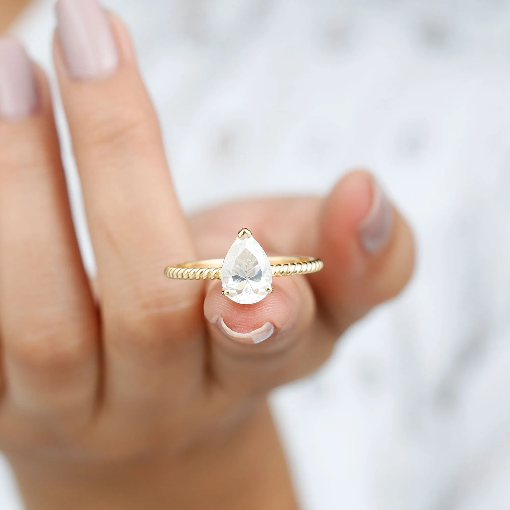 Pear Shaped Moissanite Solitaire Ring with Gold Twisted Rope
